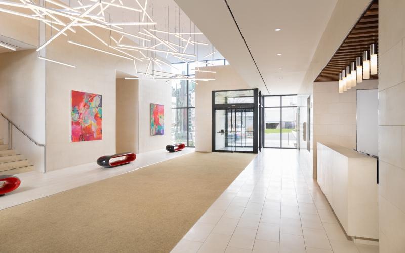 a room with a white floor and a white wall with a red car parked in it